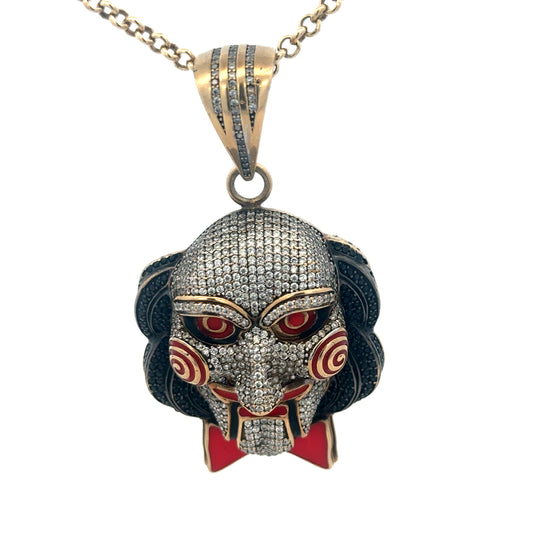 9ct yellow gold jigsaw pendant from Reeves and Sons, showcasing a detailed puzzle piece design and polished finish.