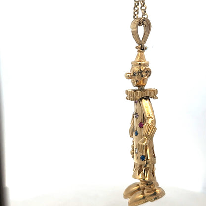 9ct yellow gold clown pendant, detailed design, from Reeves and Sons, weighs 42.5g, shown on a neutral background