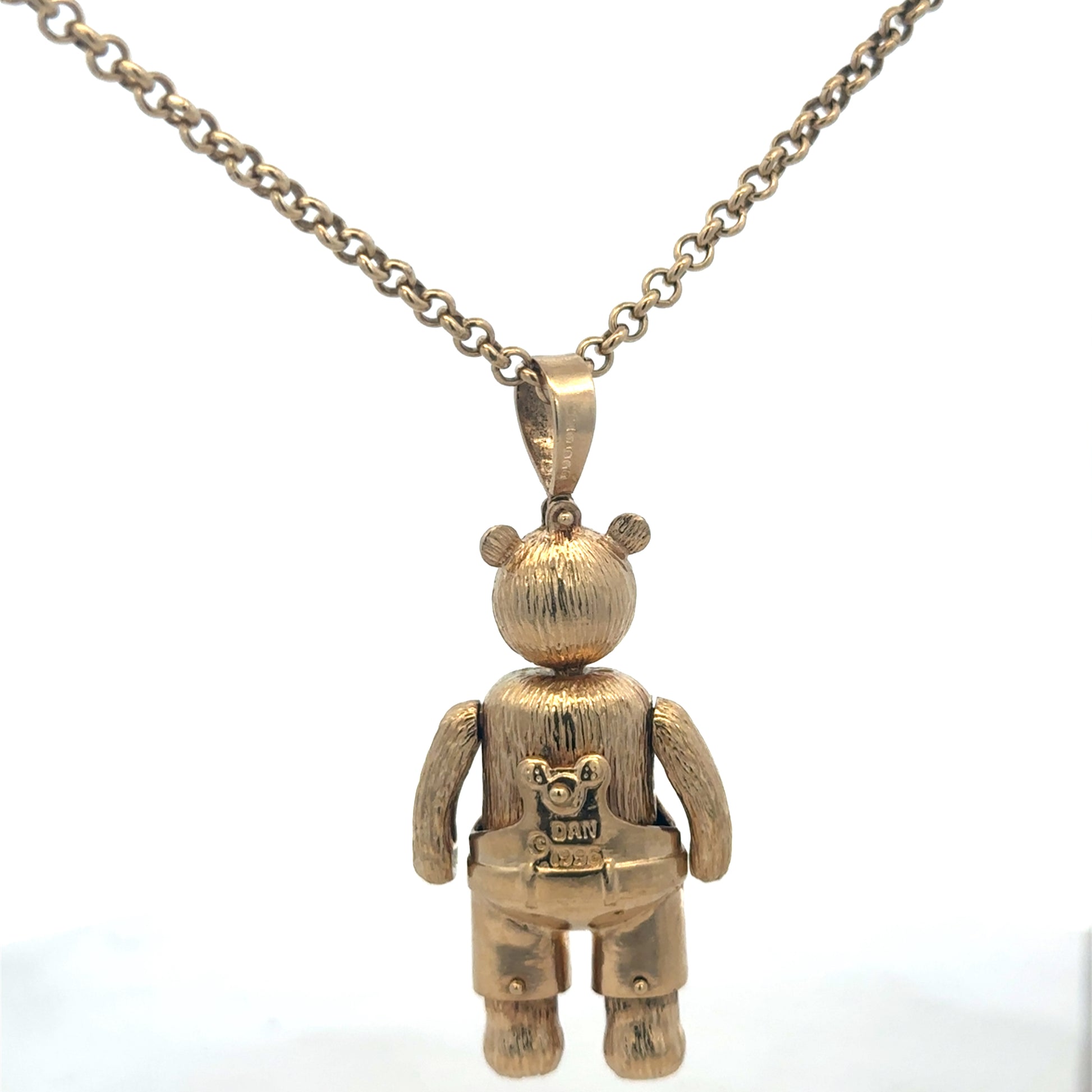 9ct yellow gold teddy bear pendant with detailed engraving, weight 20.4g, from Reeves and Sons, shown on a neutral background.