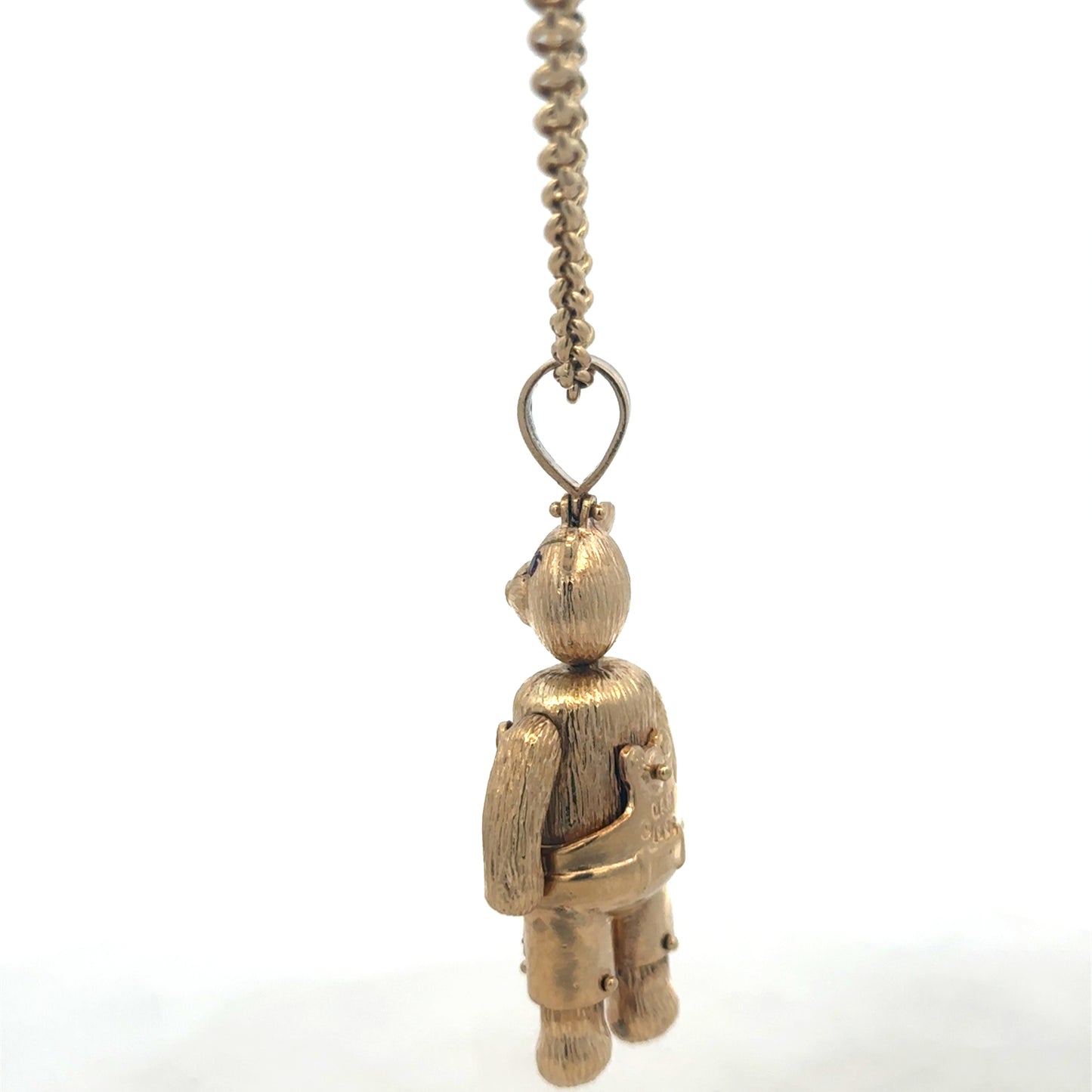 9ct yellow gold teddy bear pendant with detailed design, weighing 20.4g, from Reeves and Sons.