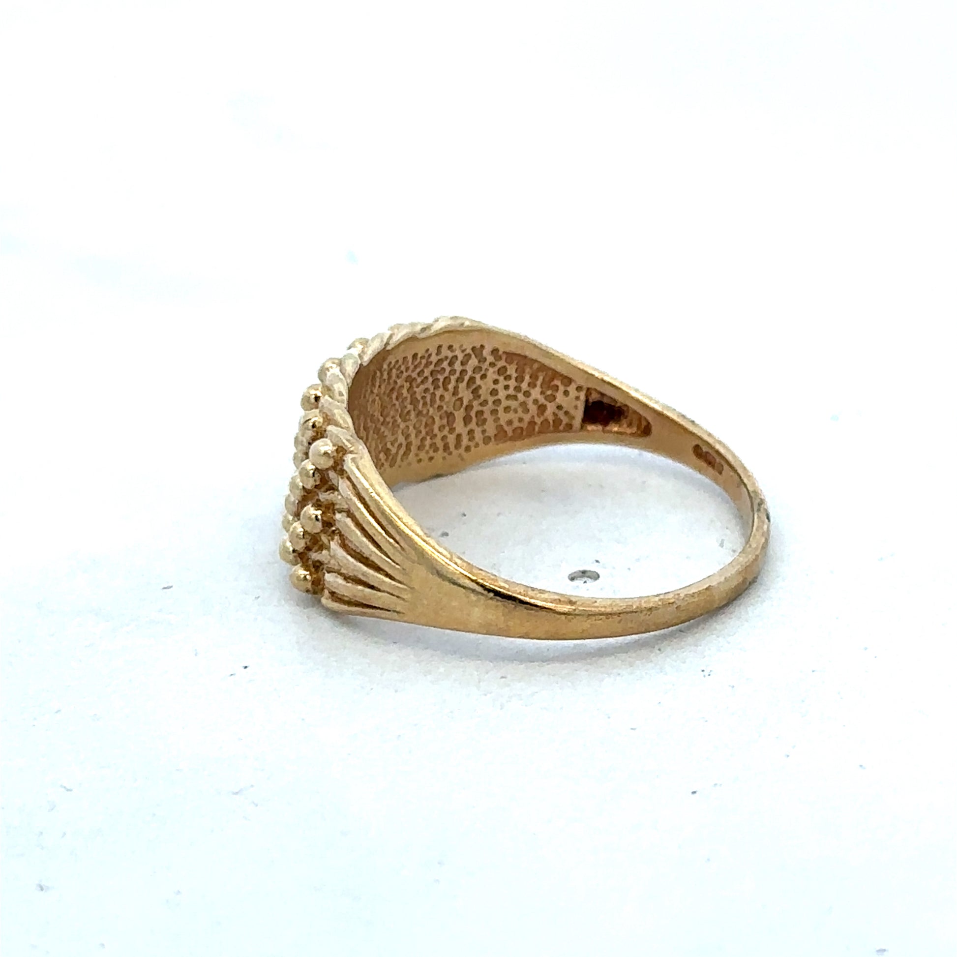 9ct yellow gold keeper ring in size W with a simple band design, crafted by Reeves and Sons.