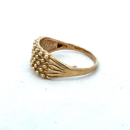 9ct yellow gold keeper ring in size W with a polished finish, designed by Reeves and Sons, shown on a plain background.