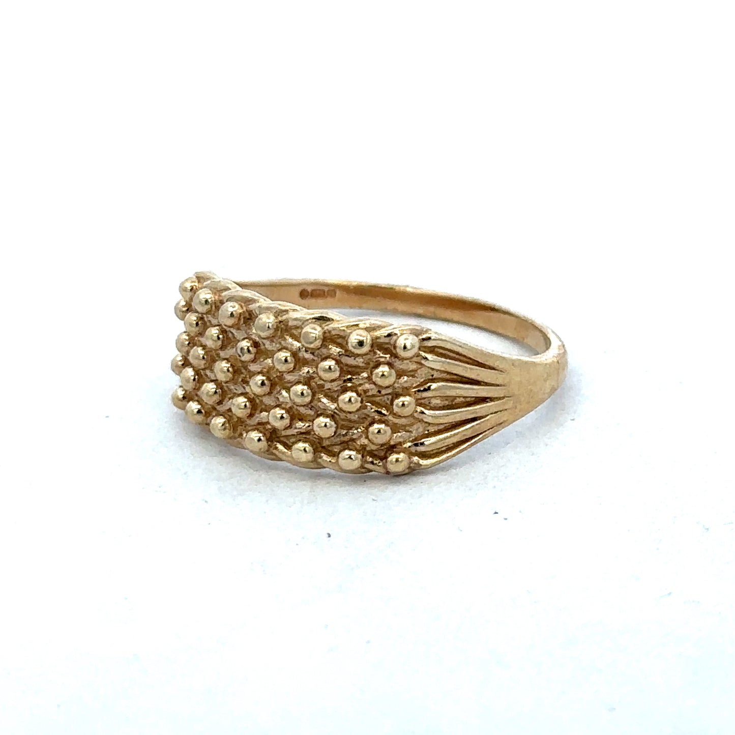 9ct yellow gold keeper ring in size W by Reeves and Sons, featuring a smooth band with a polished finish.