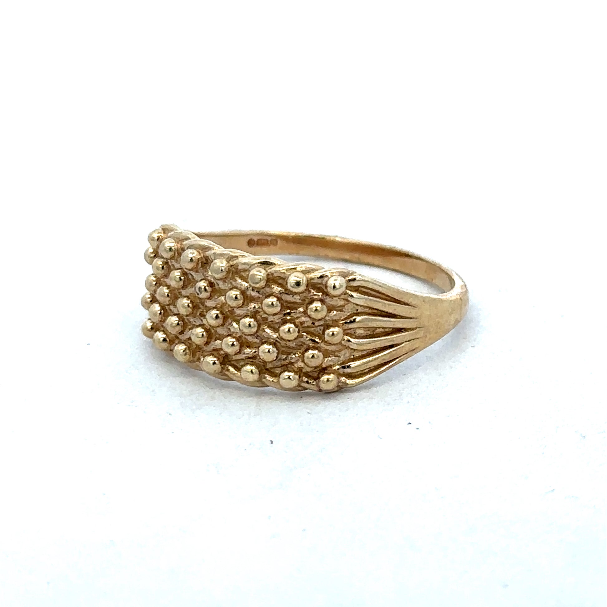 9ct yellow gold keeper ring in size W by Reeves and Sons, featuring a smooth band with a polished finish.