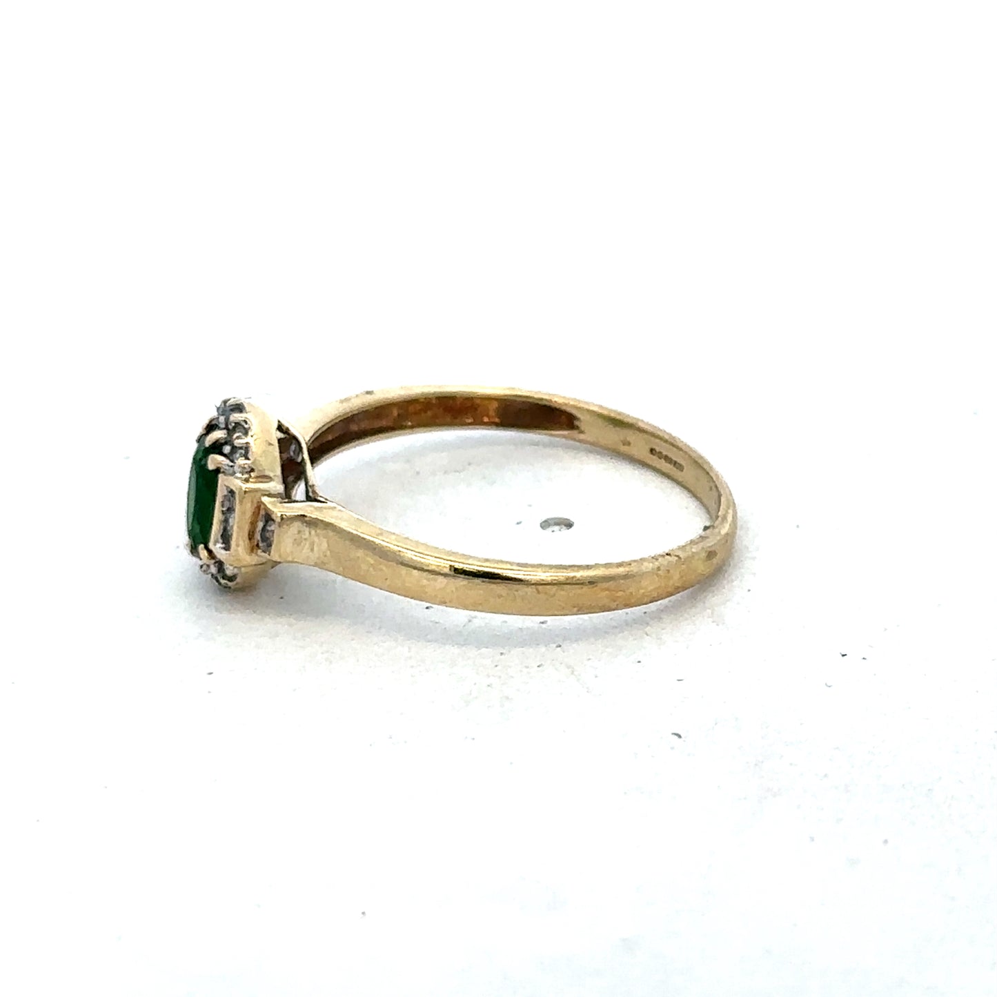 9ct yellow gold emerald and diamond ring, size R, by Reeves and Sons, showcasing a detailed design with sparkling gemstones.