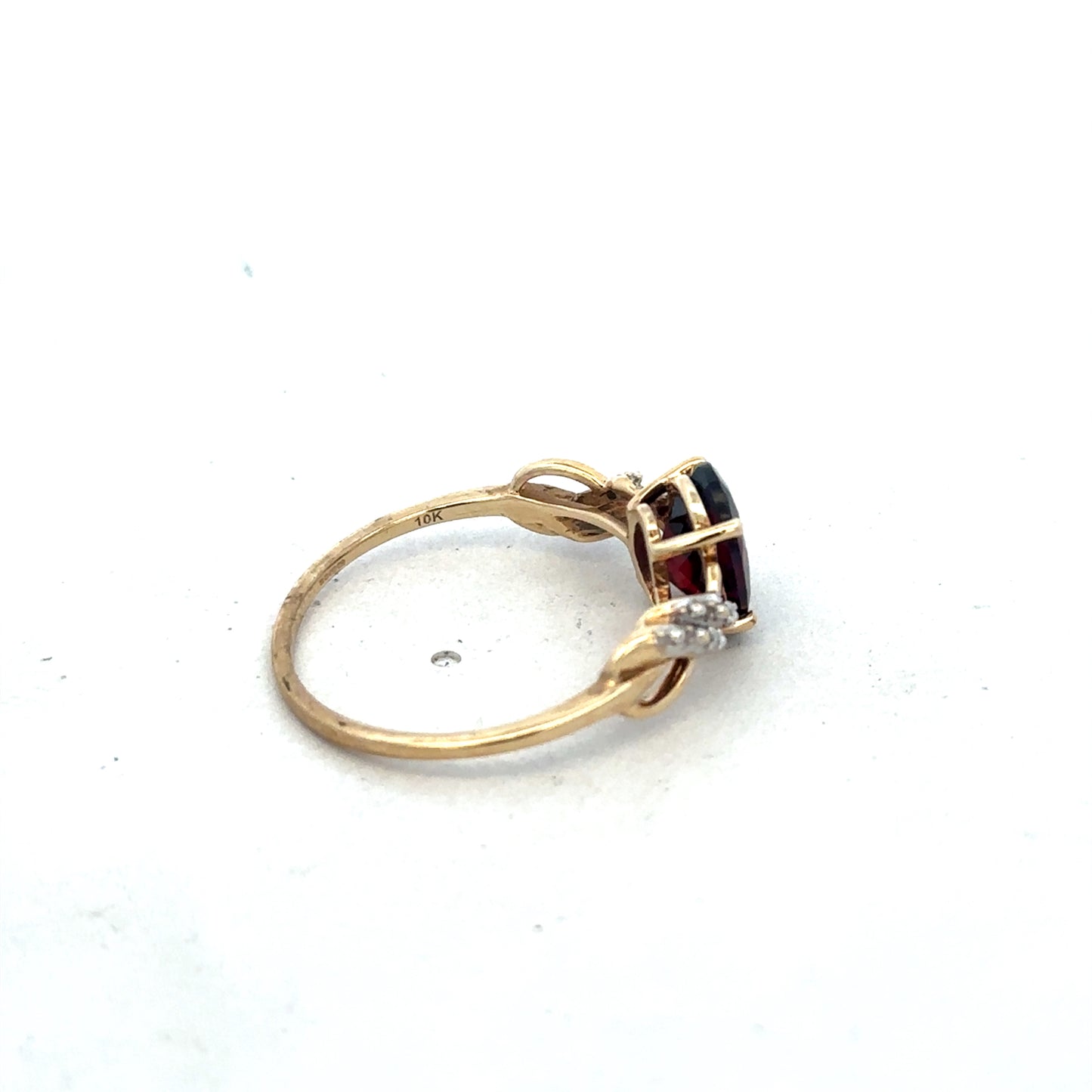 9ct yellow gold garnet and diamond ring, size R1/2, featuring a central garnet gemstone with diamond accents, by Reeves and Sons.