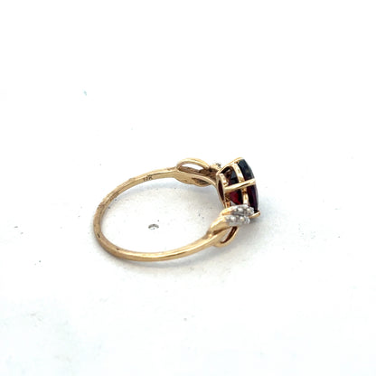9ct yellow gold garnet and diamond ring, size R1/2, featuring a central garnet gemstone with diamond accents, by Reeves and Sons.