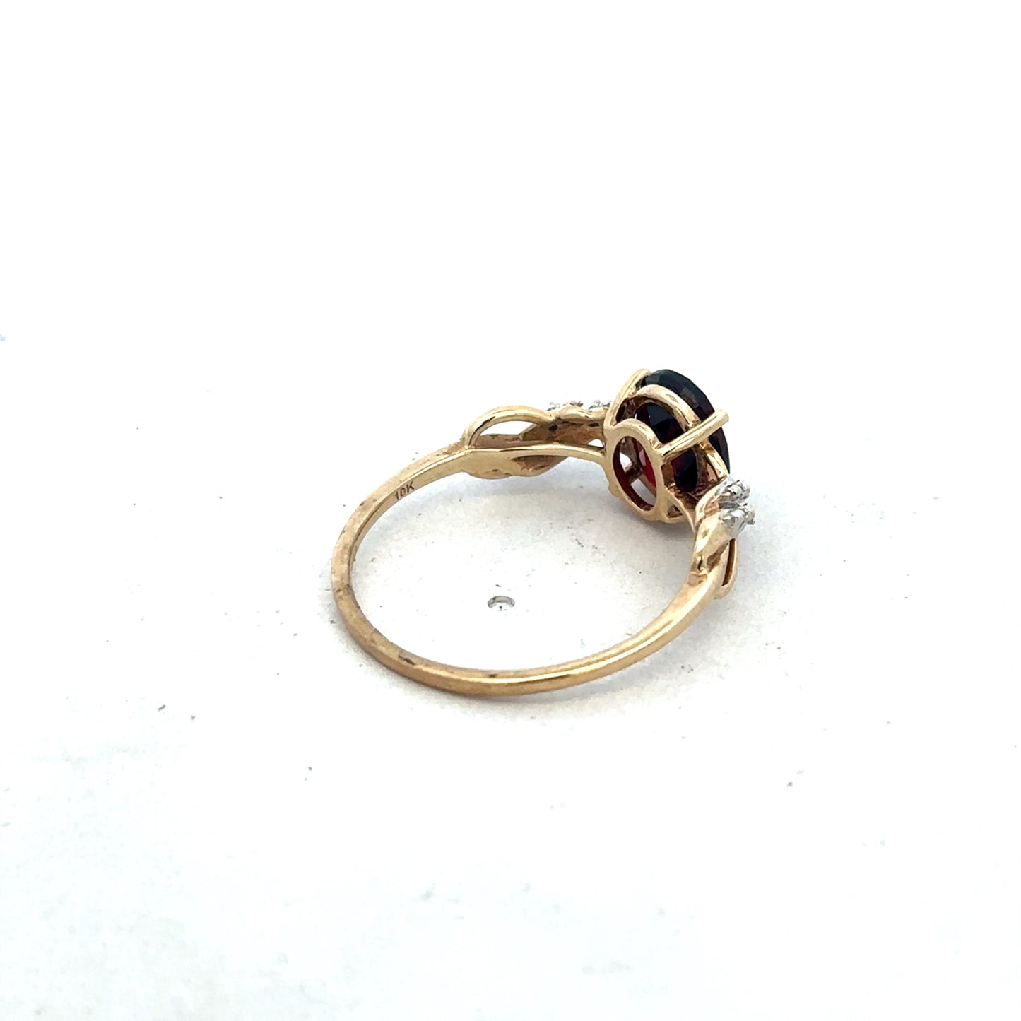 9ct yellow gold garnet and diamond ring with intricate design, size R1/2, crafted by Reeves and Sons.
