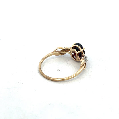 9ct yellow gold garnet and diamond ring with intricate design, size R1/2, crafted by Reeves and Sons.