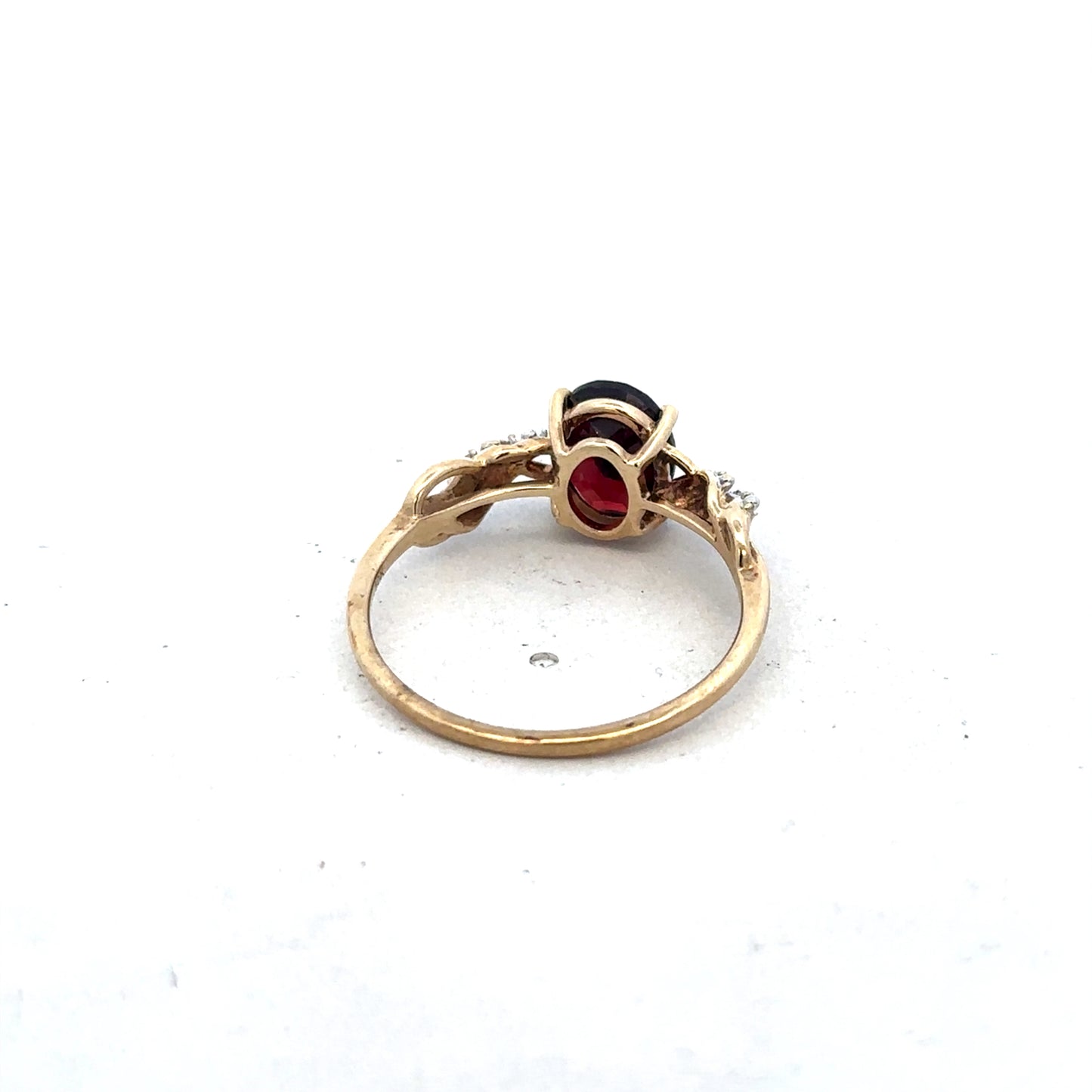 9ct yellow gold garnet and diamond ring in size R1/2, featuring a central garnet with diamond accents, by Reeves and Sons.
