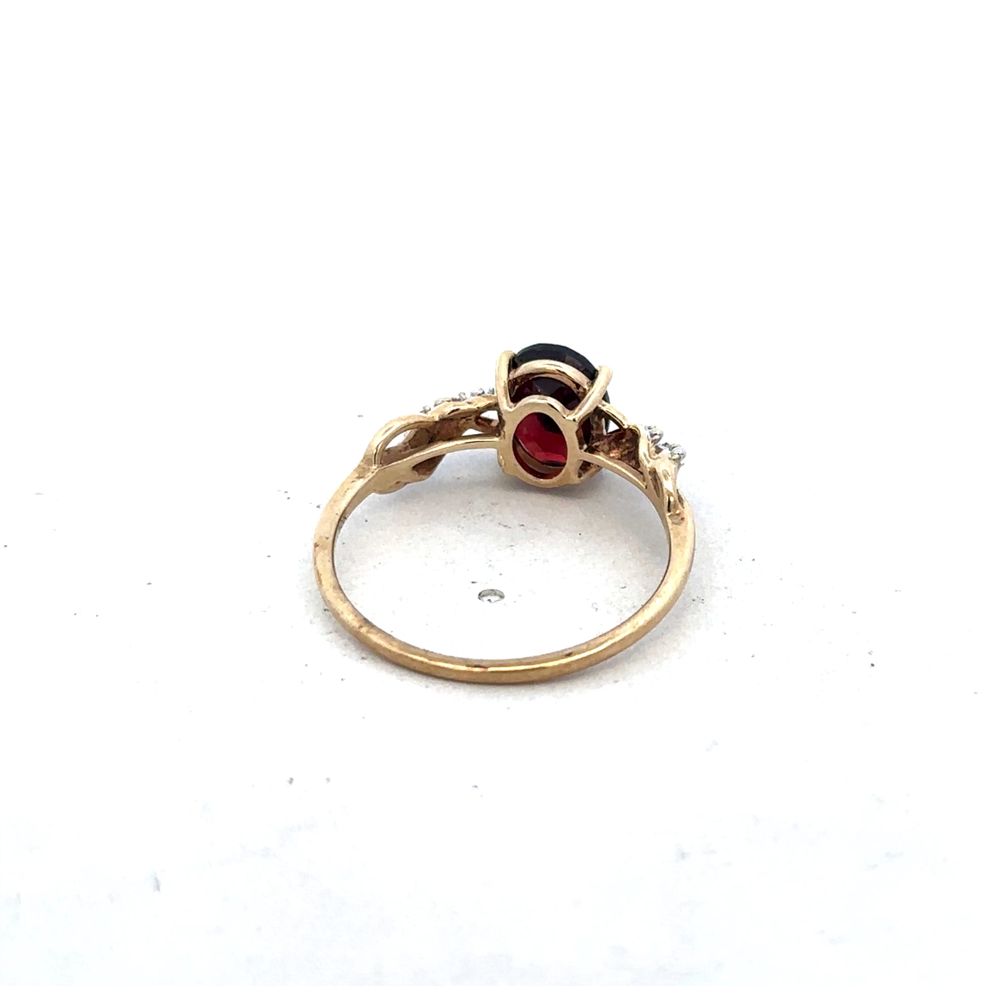 9ct yellow gold garnet and diamond ring in size R1/2, featuring a central garnet with diamond accents, by Reeves and Sons.