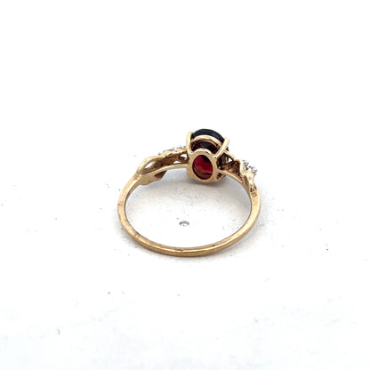 9ct yellow gold garnet and diamond ring in size R1/2, featuring a central garnet with diamond accents, by Reeves and Sons.