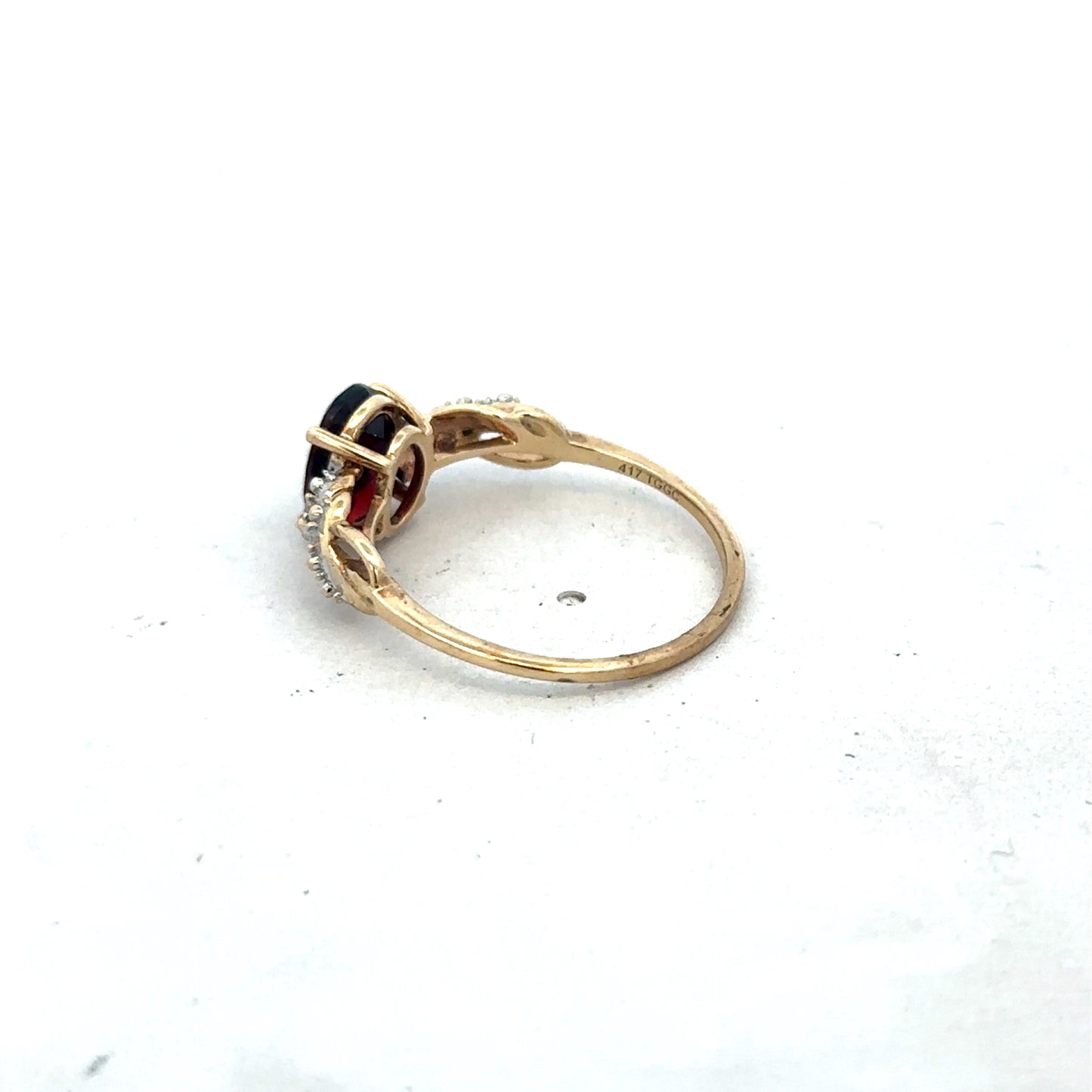 9ct yellow gold garnet and diamond ring, size R1/2, featuring a central garnet gemstone and diamond accents, by Reeves and Sons.