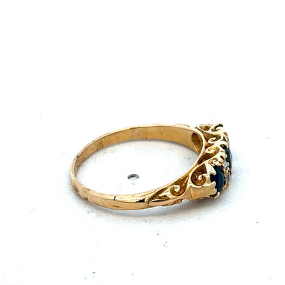 18ct yellow gold sapphire and diamond ring by Reeves and Sons, size O, featuring a central sapphire and sparkling diamonds.