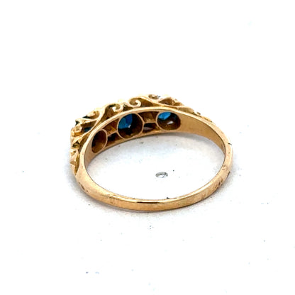 18ct yellow gold sapphire and diamond ring by Reeves and Sons, size O, featuring a central sapphire and sparkling diamonds.