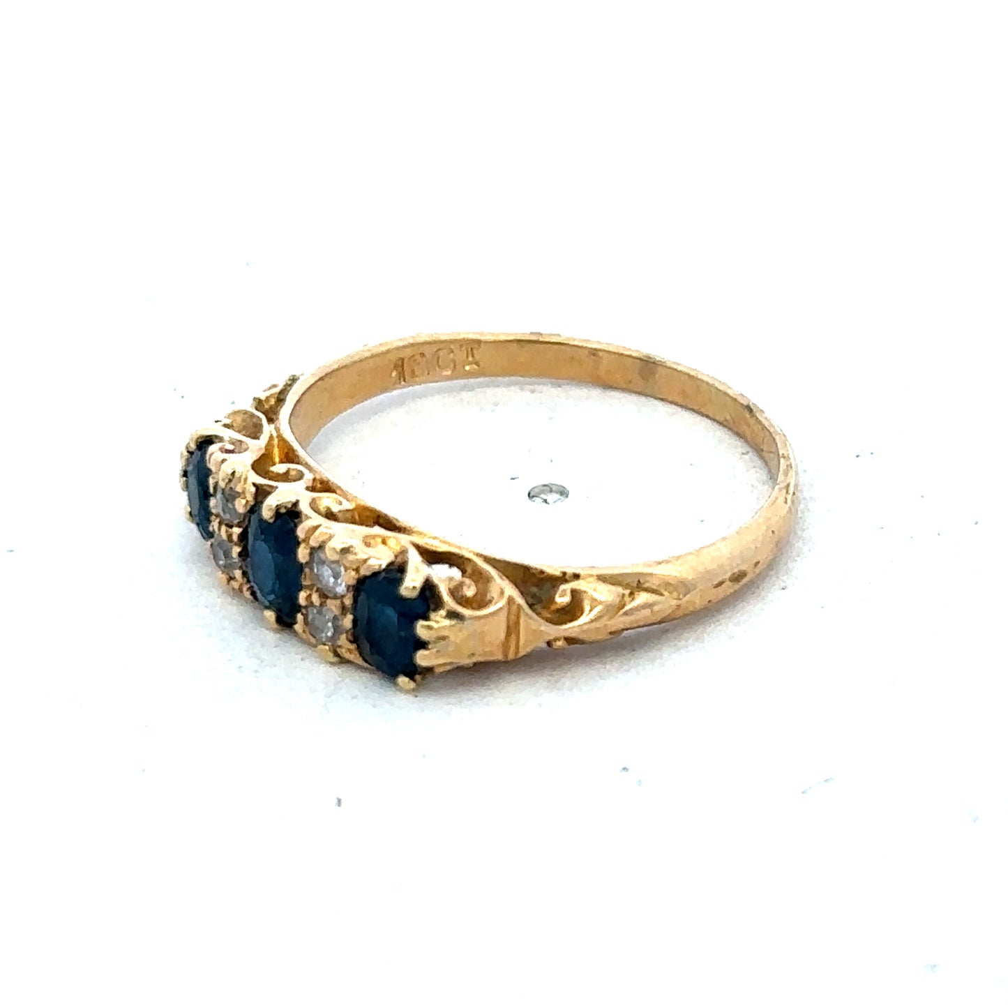 18ct yellow gold sapphire and diamond ring with a central blue sapphire and sparkling diamonds, size O, by Reeves and Sons.
