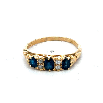 18ct yellow gold sapphire and diamond ring by Reeves and Sons, size O, featuring a central sapphire with diamond accents.