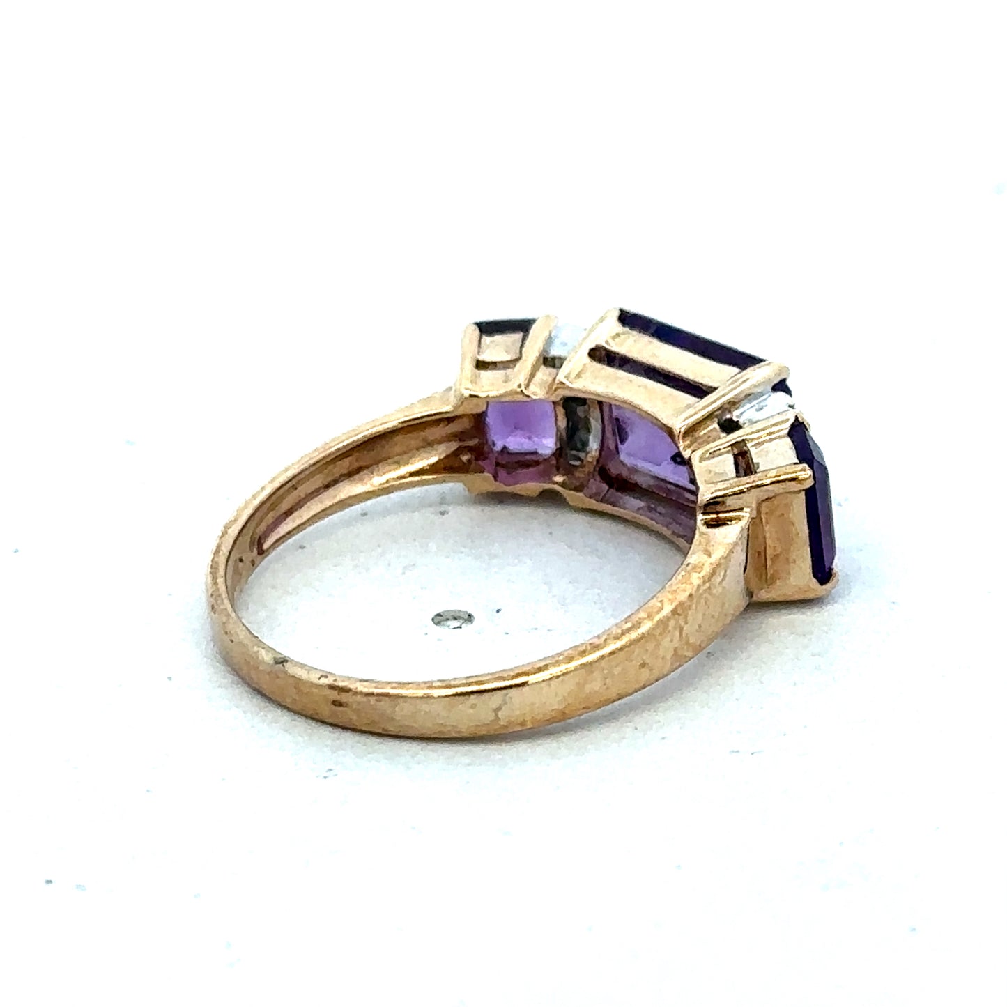 9ct yellow gold amethyst and diamond ring showcasing a central amethyst gemstone with diamond accents, size N, Reeves and Sons.