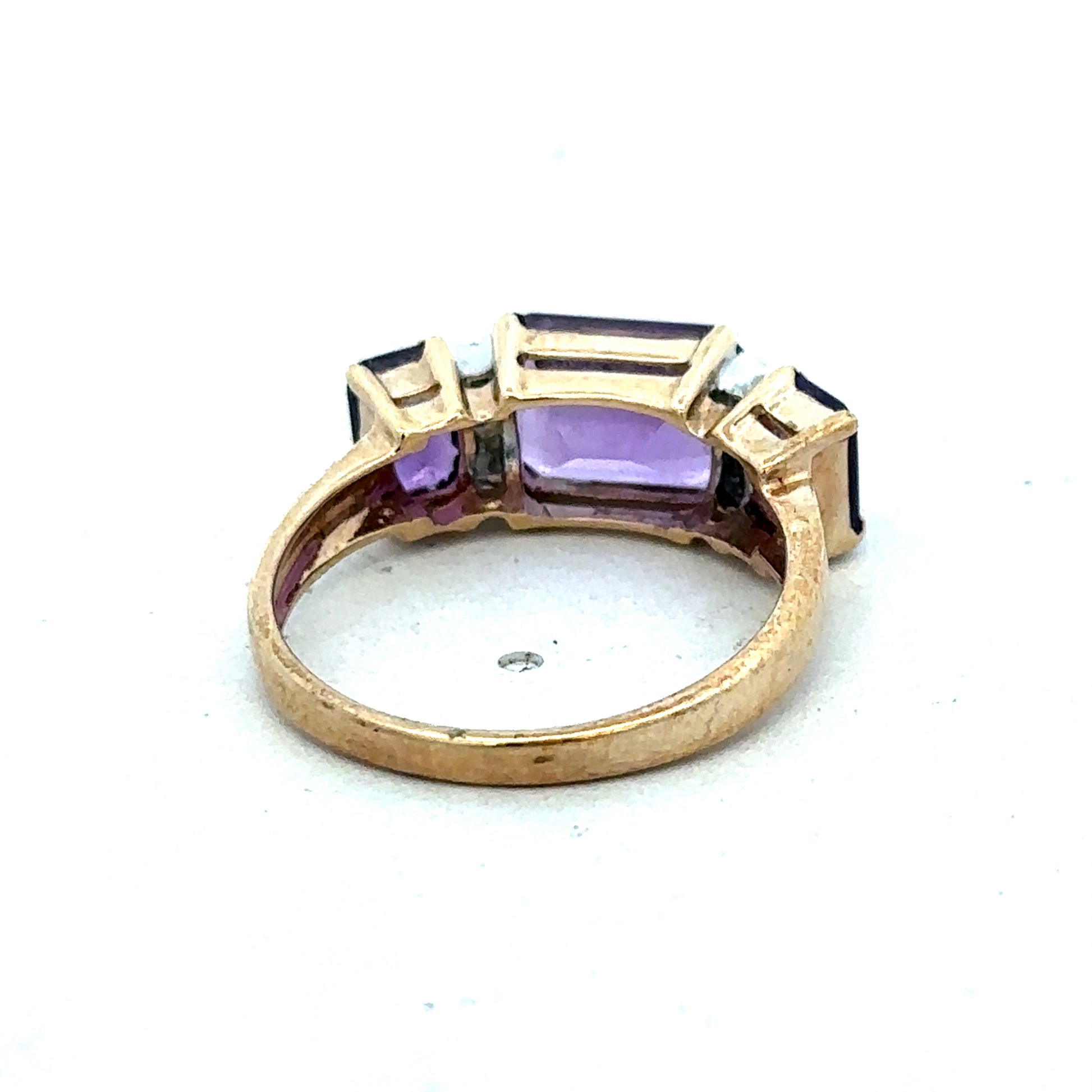 9ct yellow gold amethyst and diamond ring with size N by Reeves and Sons, featuring a central purple gemstone and sparkling accents