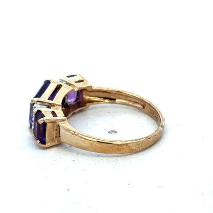 9ct yellow gold amethyst and diamond ring by Reeves and Sons, size N, featuring a central purple amethyst gemstone with diamond accents.