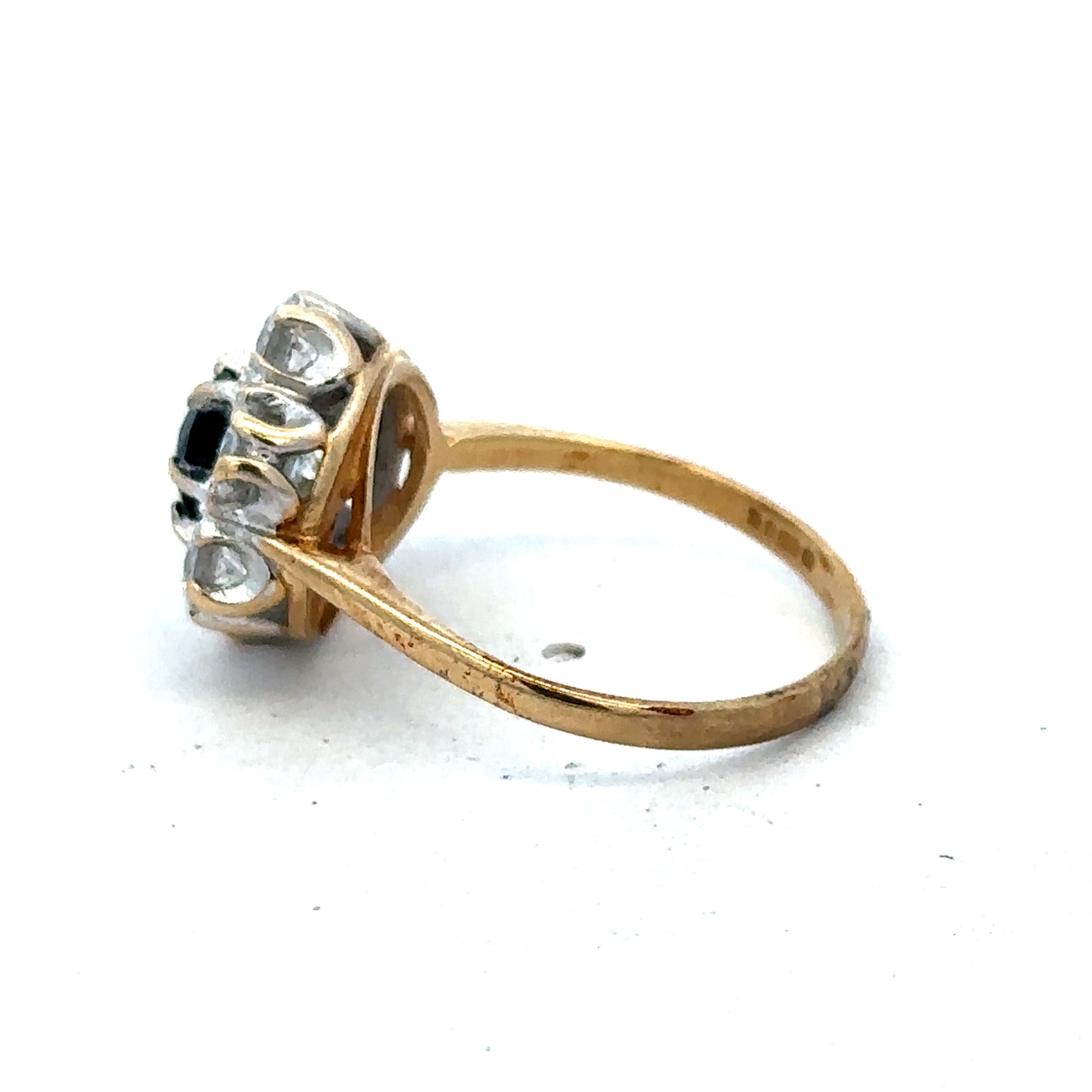 9ct yellow gold ring in size O with smooth band, crafted by Reeves and Sons, shown resting on a neutral background.