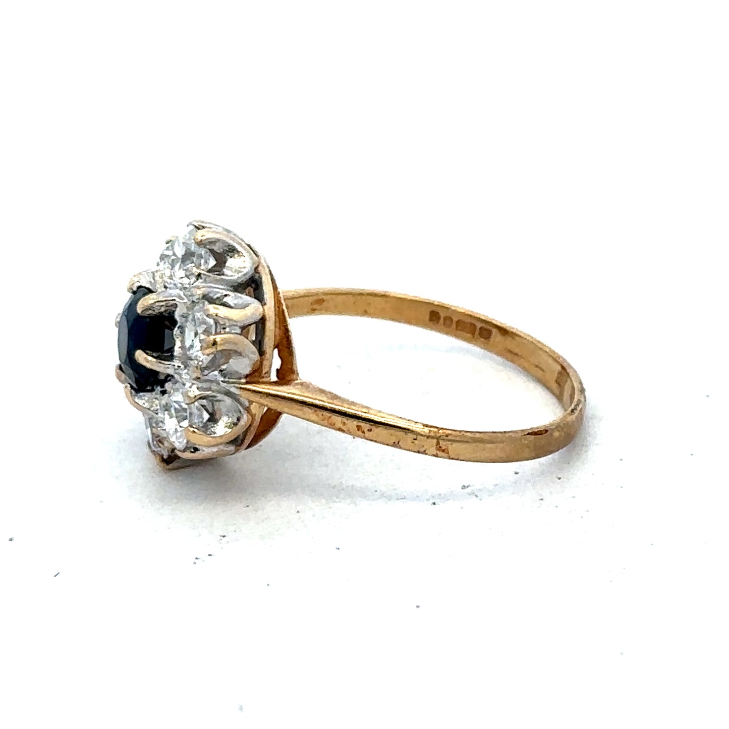 9ct yellow gold ring in size O by Reeves and Sons, featuring a simple band design, shown in a close-up image.