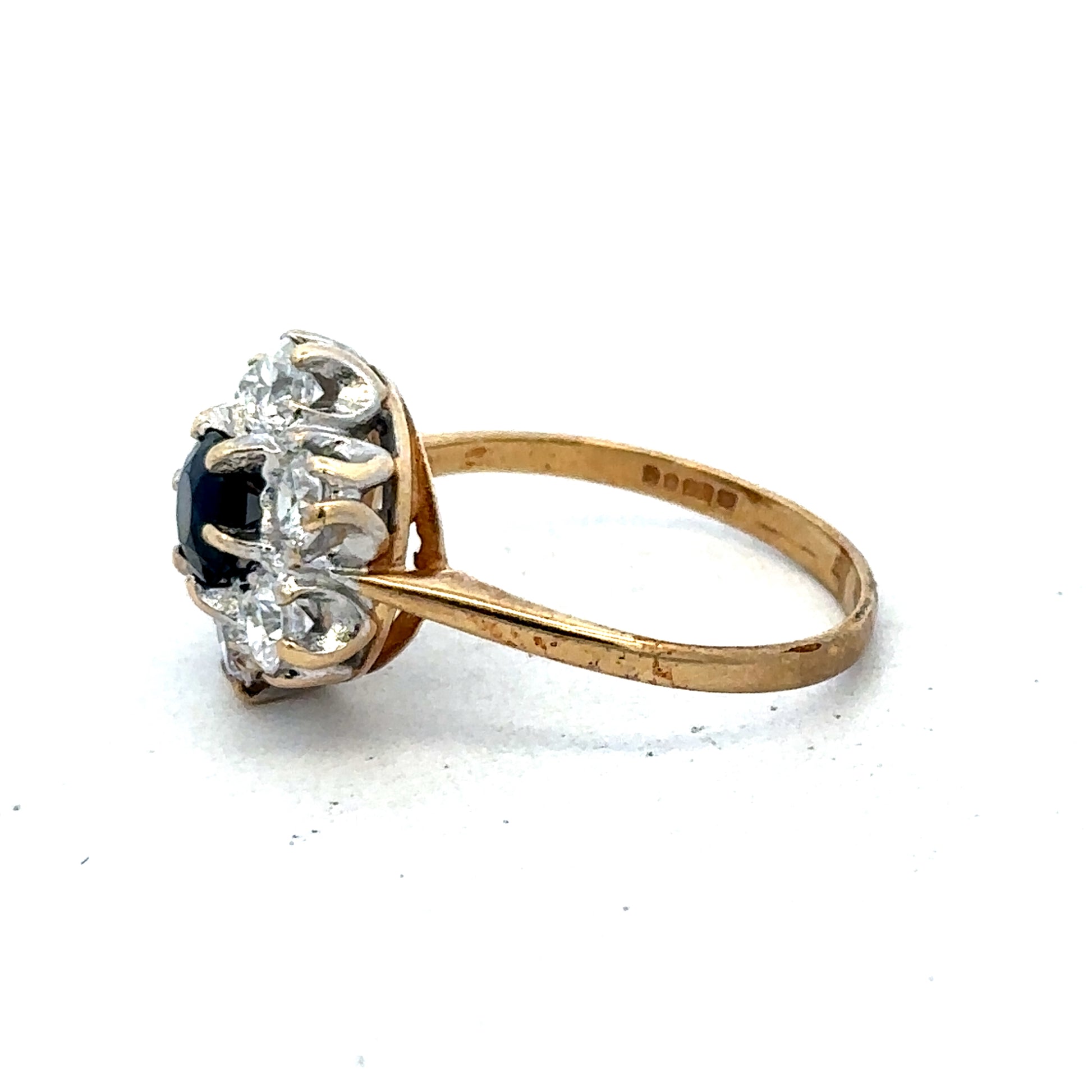 9ct yellow gold ring in size O by Reeves and Sons, featuring a simple band design, shown in a close-up image.