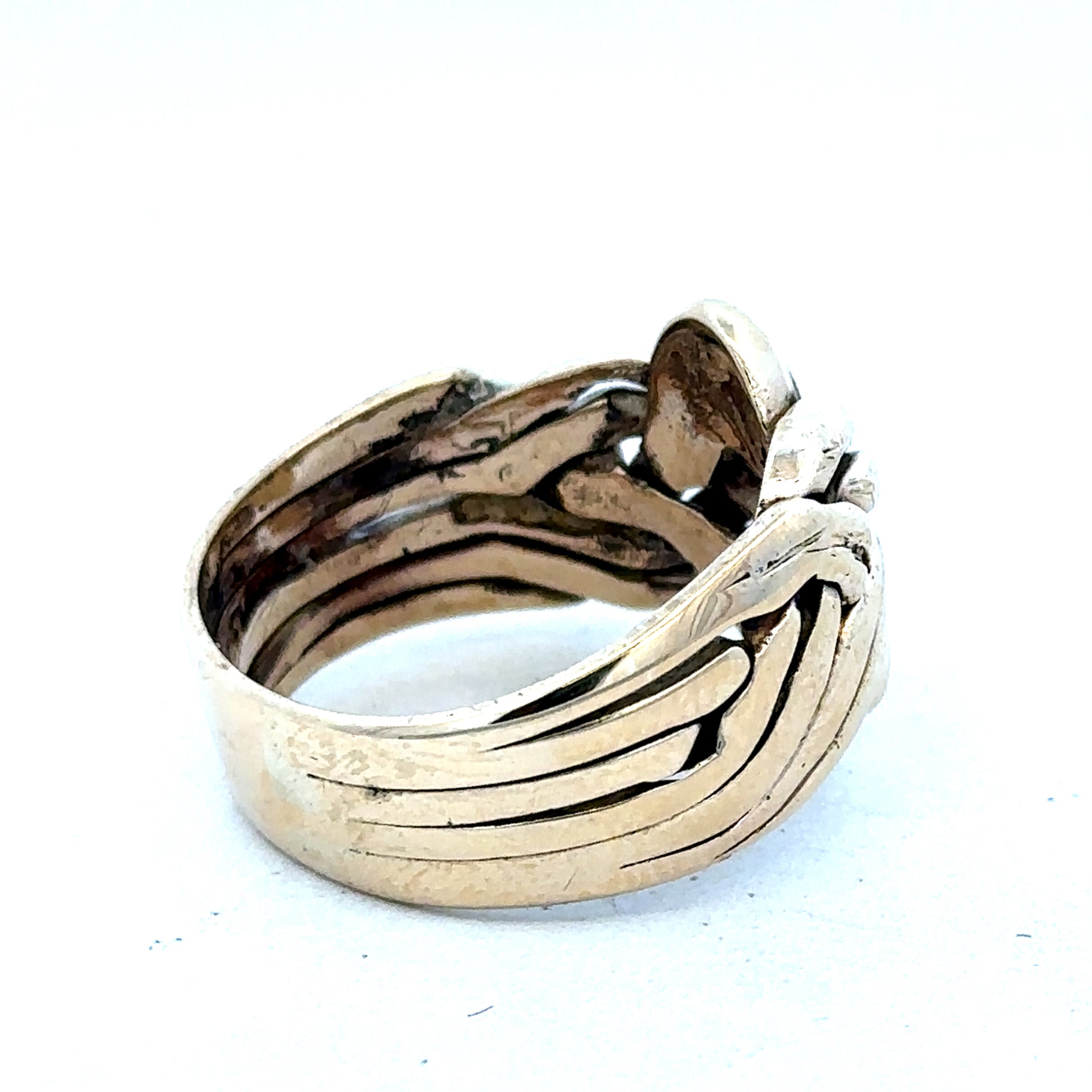 9ct yellow gold puzzle ring in size U with intricate design, crafted by Reeves and Sons, shown in close-up.