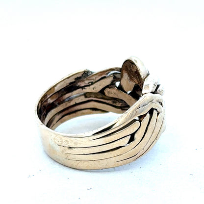9ct yellow gold puzzle ring in size U with intricate design, crafted by Reeves and Sons, shown in close-up.