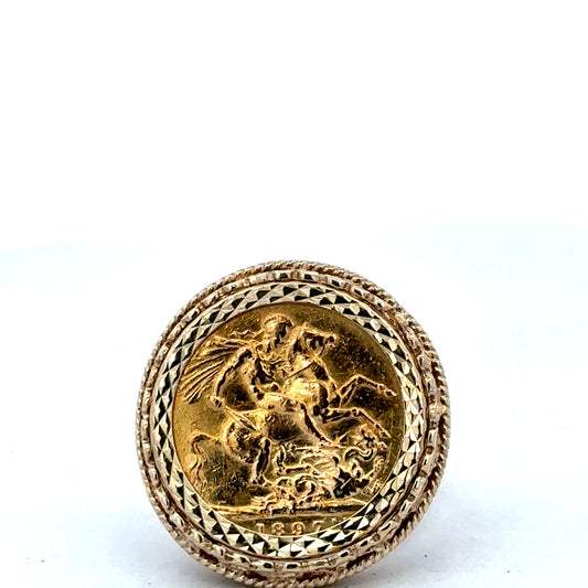 9ct yellow gold Sovereign ring by Reeves and Sons, size X, with detailed engraved design and classic royal emblem.