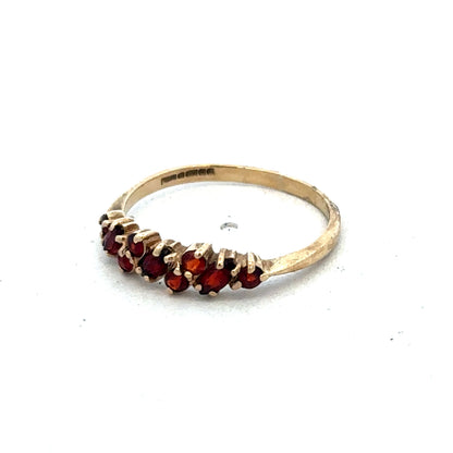 9ct yellow gold ring in size N by Reeves and Sons, showcasing a smooth polished band on a white background.