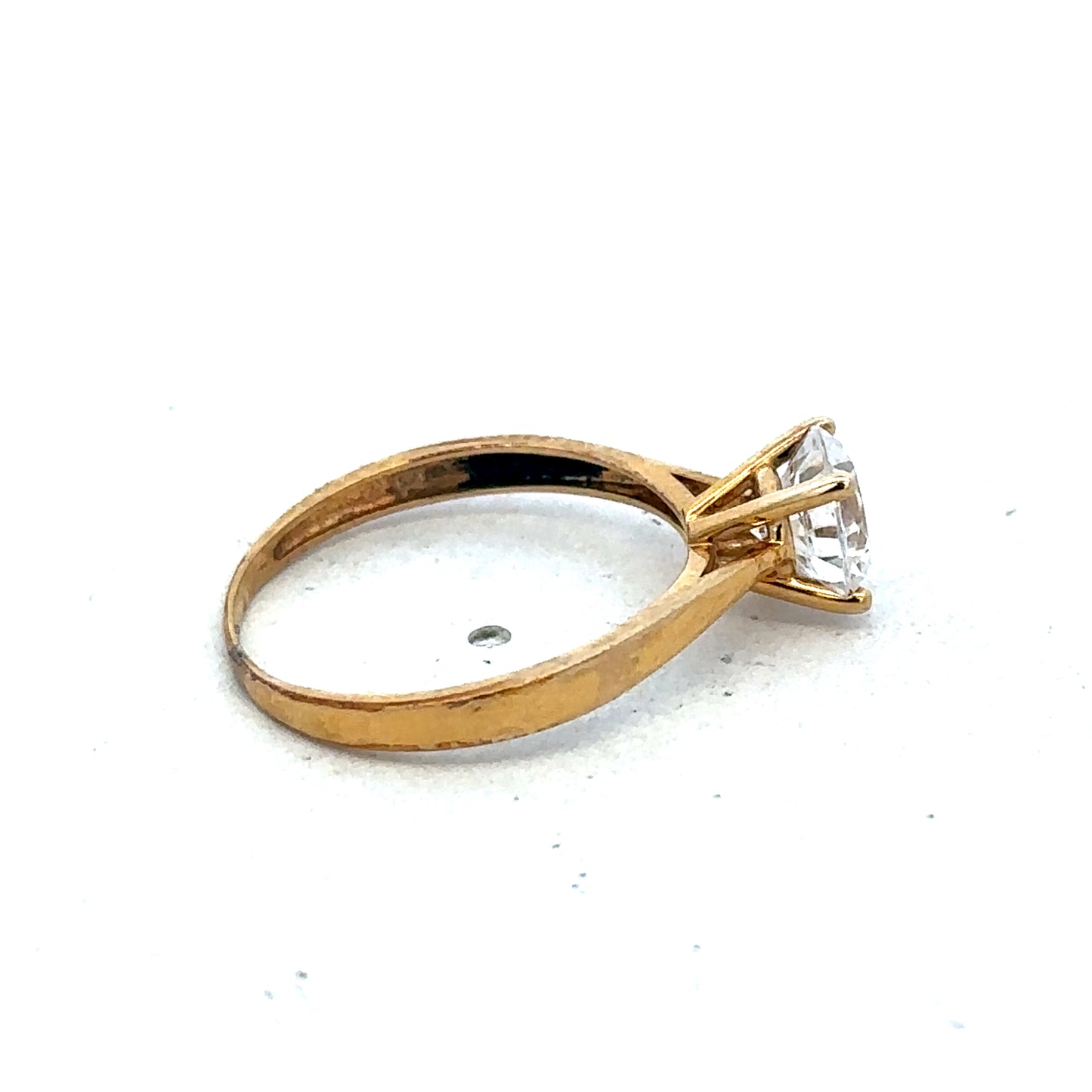 9ct yellow gold ring size L by Reeves and Sons, close-up of polished band showing smooth finish and classic design.