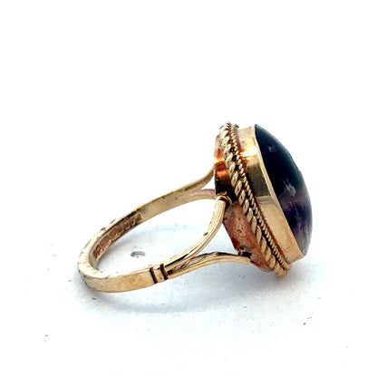 9ct yellow gold ring size L from Reeves and Sons, close-up view showing smooth band and polished finish.