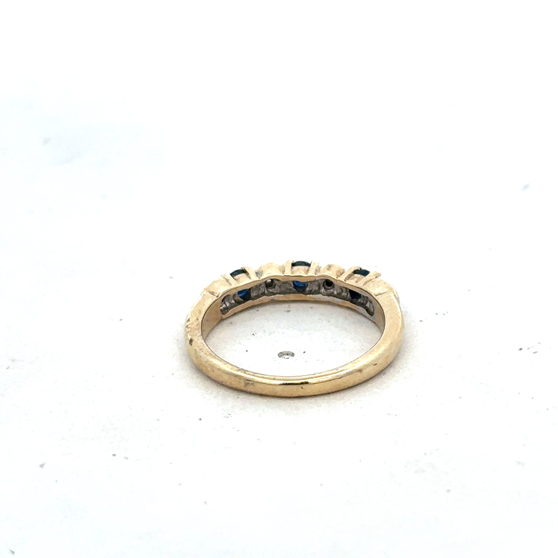9ct yellow gold sapphire and diamond ring in size M 1/2 with Reeves and Sons branding, featuring a central sapphire and diamond accents.