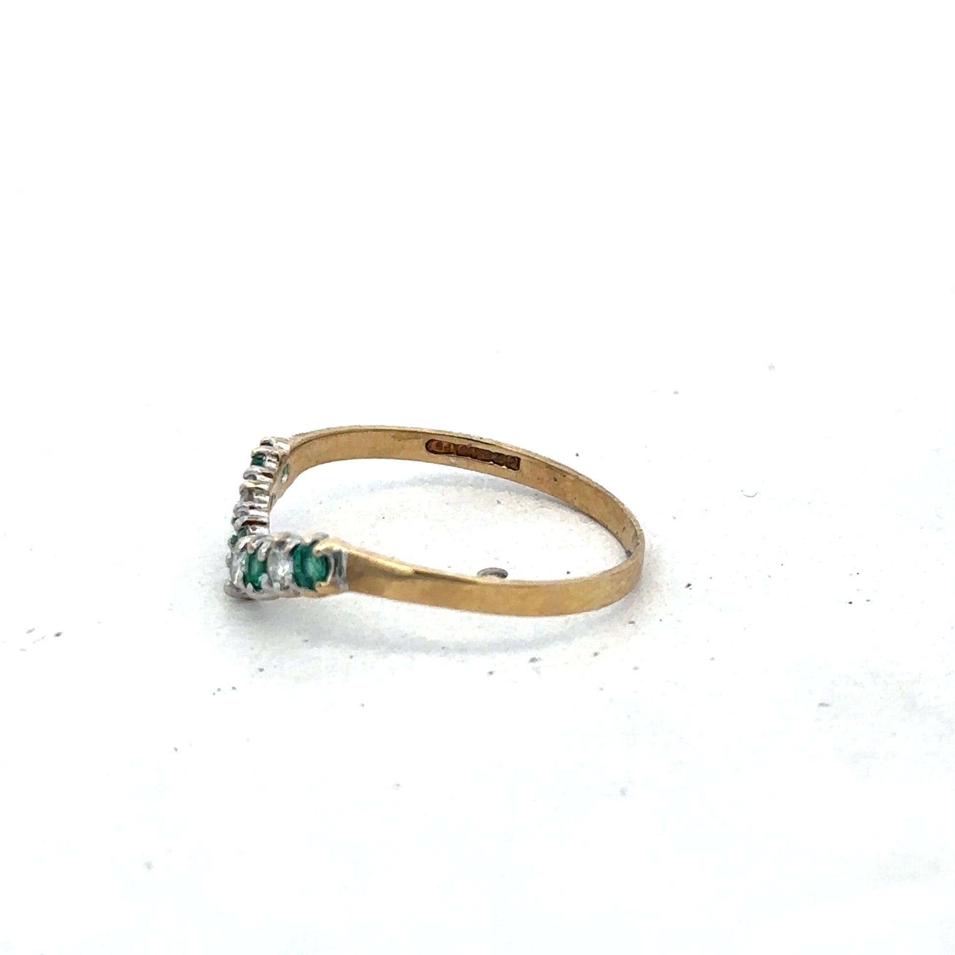 9ct yellow gold emerald and diamond ring featuring a central emerald and surrounding diamonds, size O1/2, by Reeves and Sons.