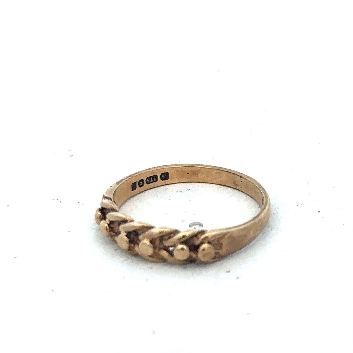 9ct yellow gold keeper ring in size K with a simple band design, crafted by Reeves and Sons.