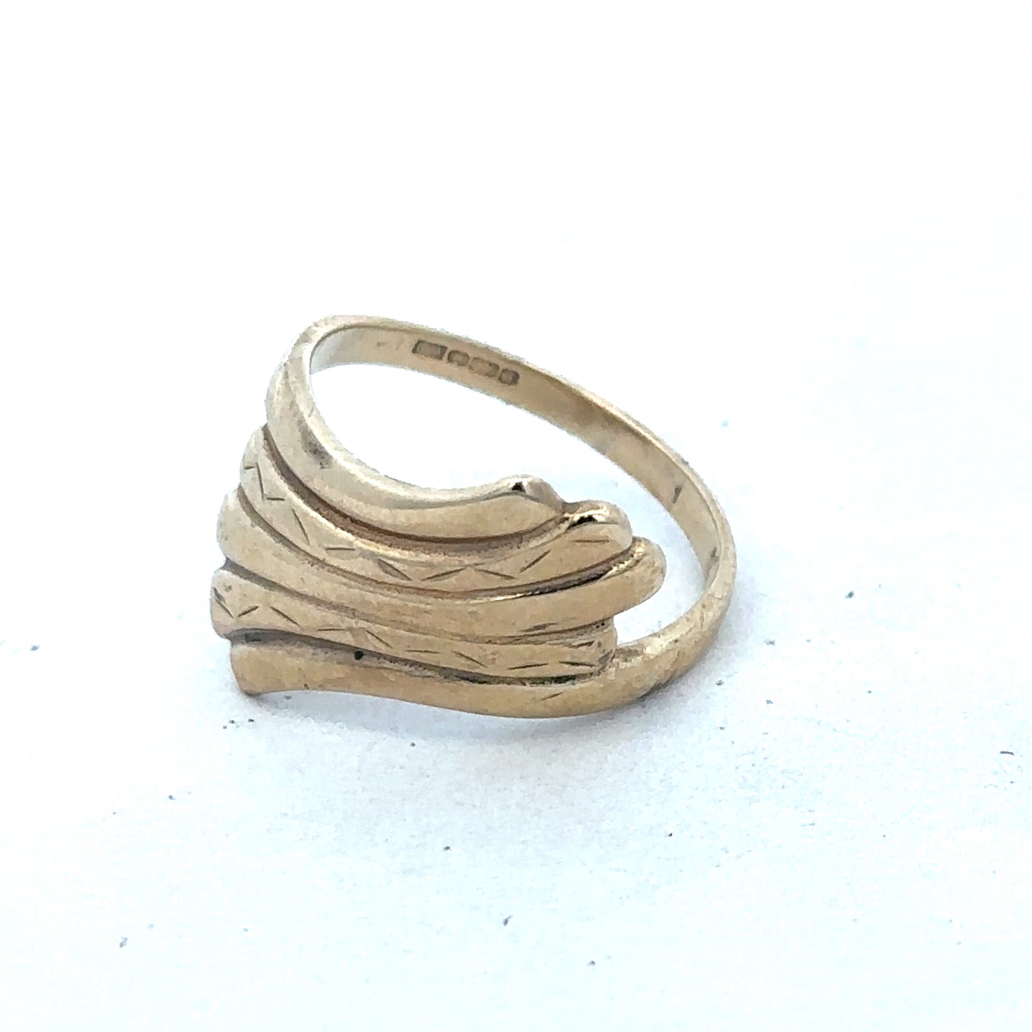 9ct yellow gold ring size N1/2 by Reeves and Sons, close-up of polished gold band with engraved details.