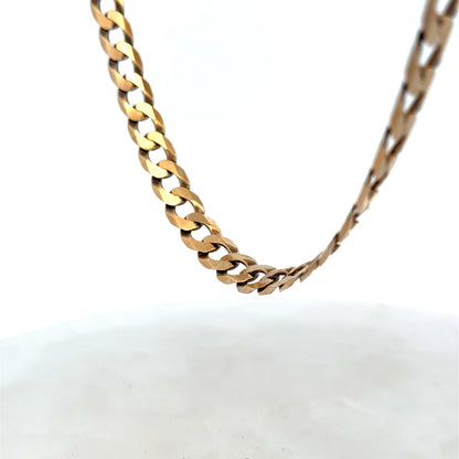 9ct yellow gold curb chain weighing 30.1g, crafted by Reeves and Sons, shown in a detailed close-up image.