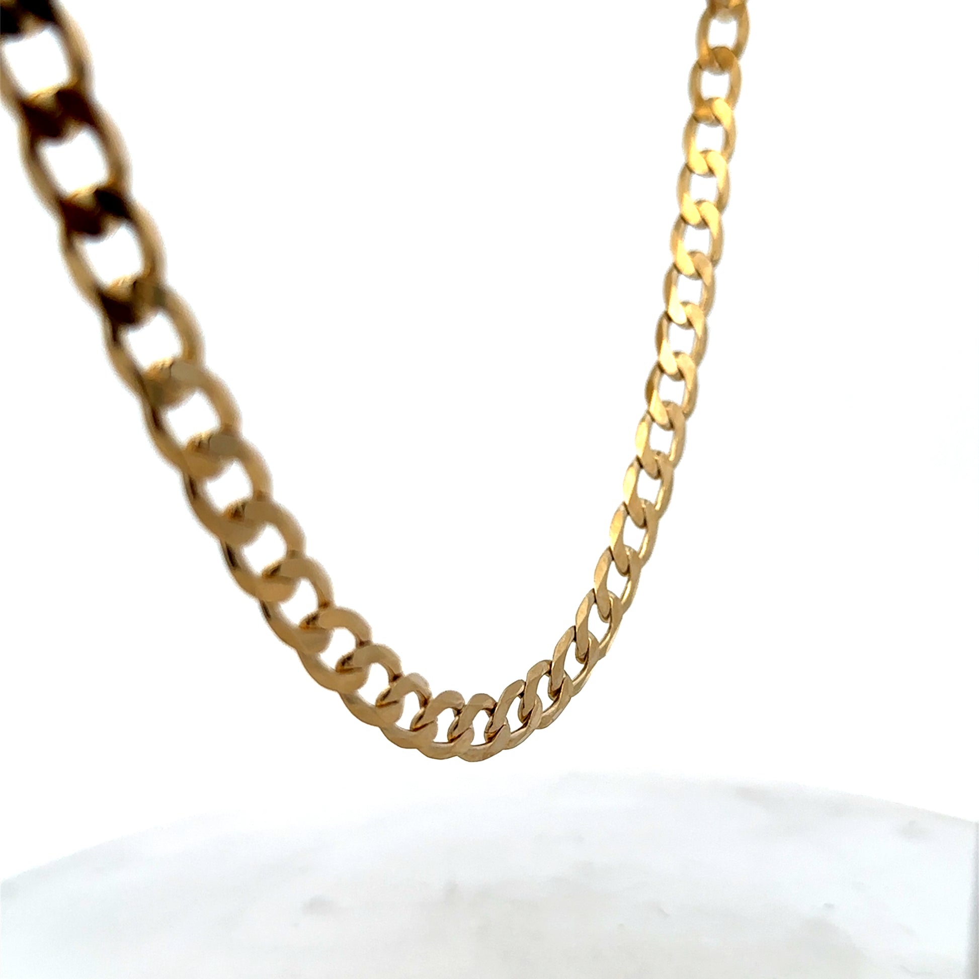 9ct yellow gold curb chain with a polished finish, weighing 27.7g, showcasing its sturdy links and classic design.