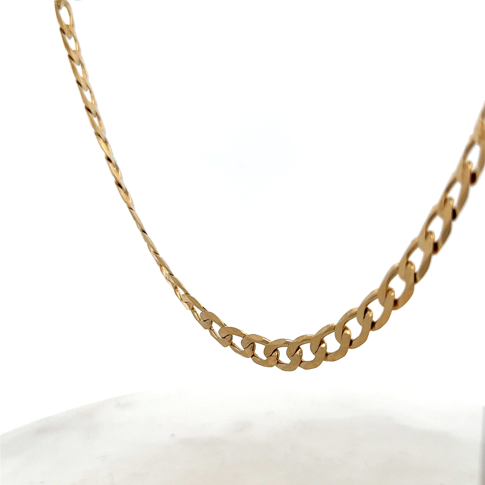 Reeves and Sons 9ct yellow gold curb chain, 27.7g, with detailed links, shown in close-up image.