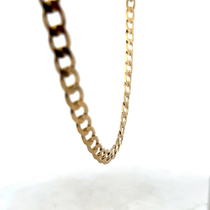 Reeves and Sons 9ct yellow gold curb chain with a 27.7g weight, featuring interlocking oval links on a plain background.
