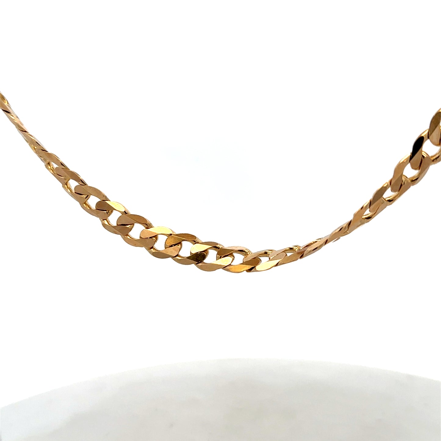 9ct yellow gold curb chain, Reeves and Sons, weighing 44.3g, with detailed links and polished finish, shown in close-up image.