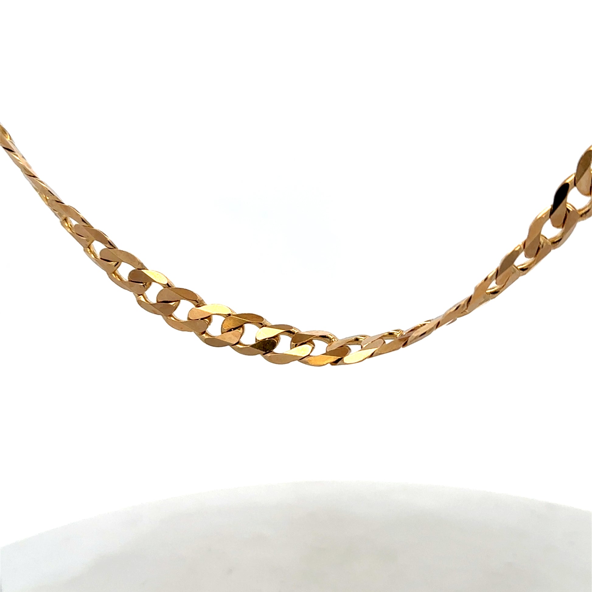 9ct yellow gold curb chain, Reeves and Sons, weighing 44.3g, with detailed links and polished finish, shown in close-up image.