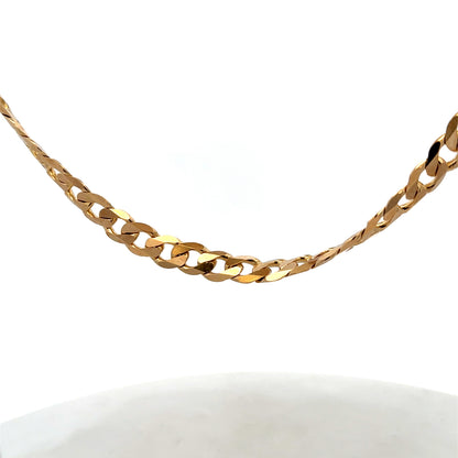9ct yellow gold curb chain, Reeves and Sons, weighing 44.3g, with detailed links and polished finish, shown in close-up image.