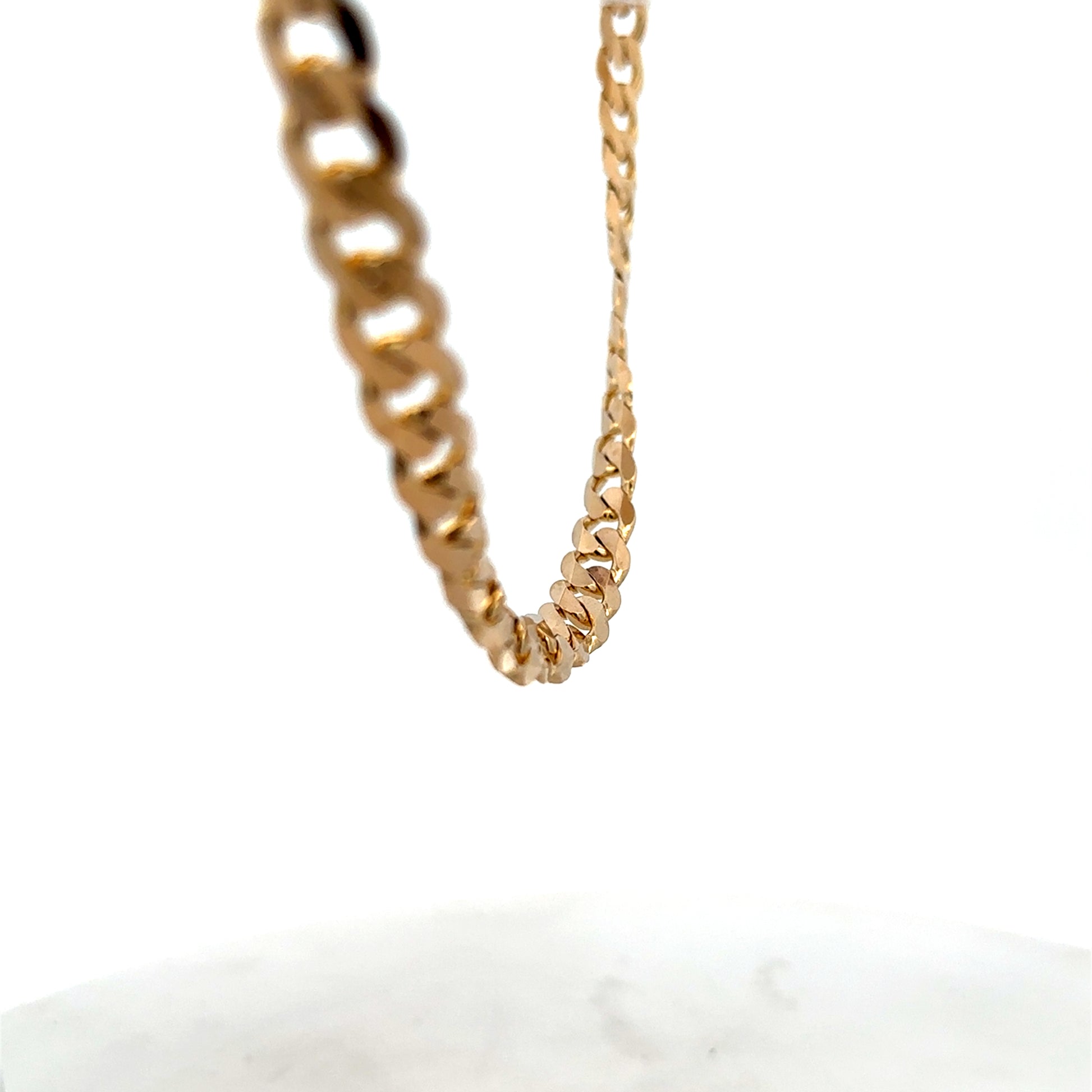 9ct yellow gold curb chain with a secure clasp, weighing 44.3g, from Reeves and Sons, displayed against a neutral background.