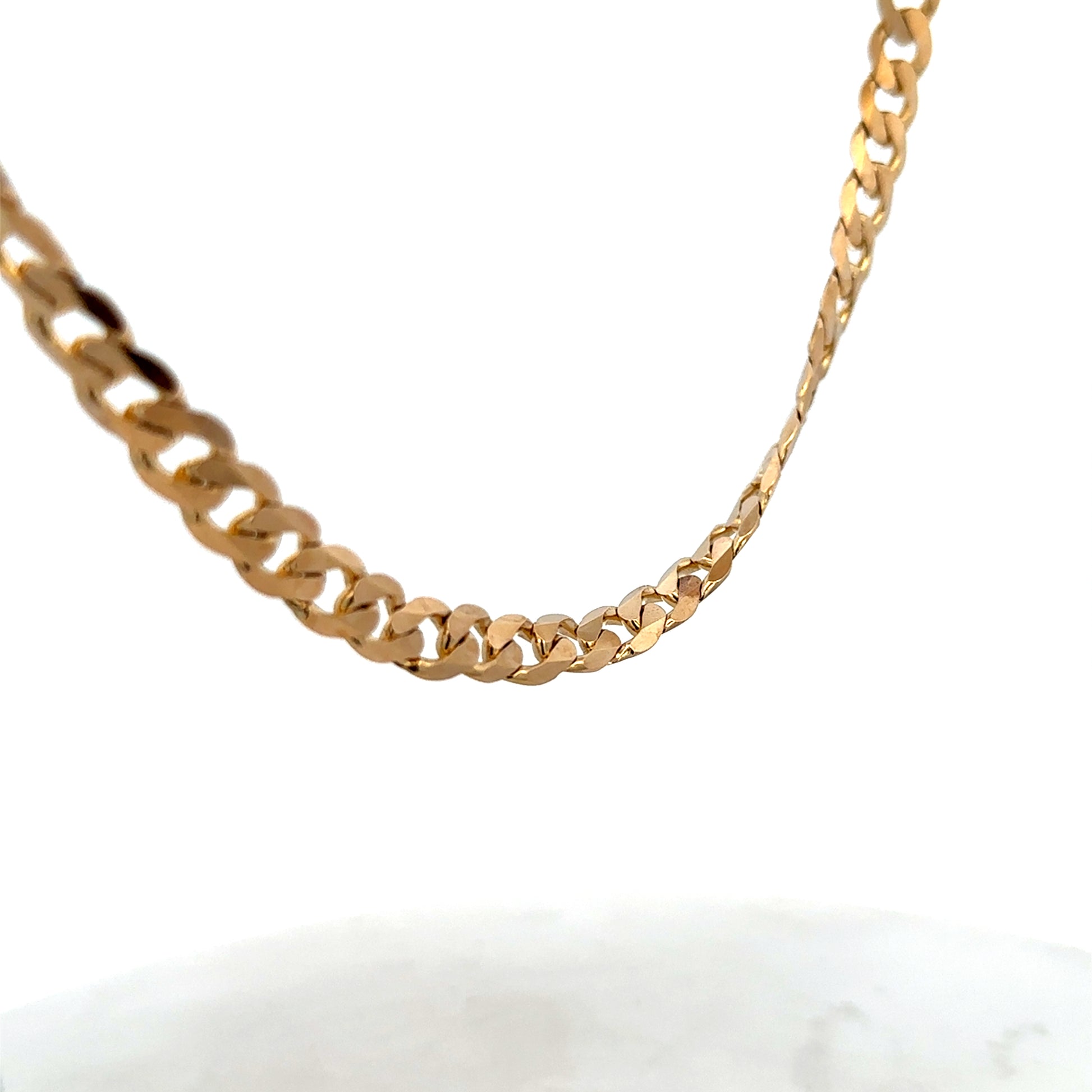 9ct yellow gold curb chain, Reeves and Sons, 44.3g, close-up view showing the linked chain design and polished finish.