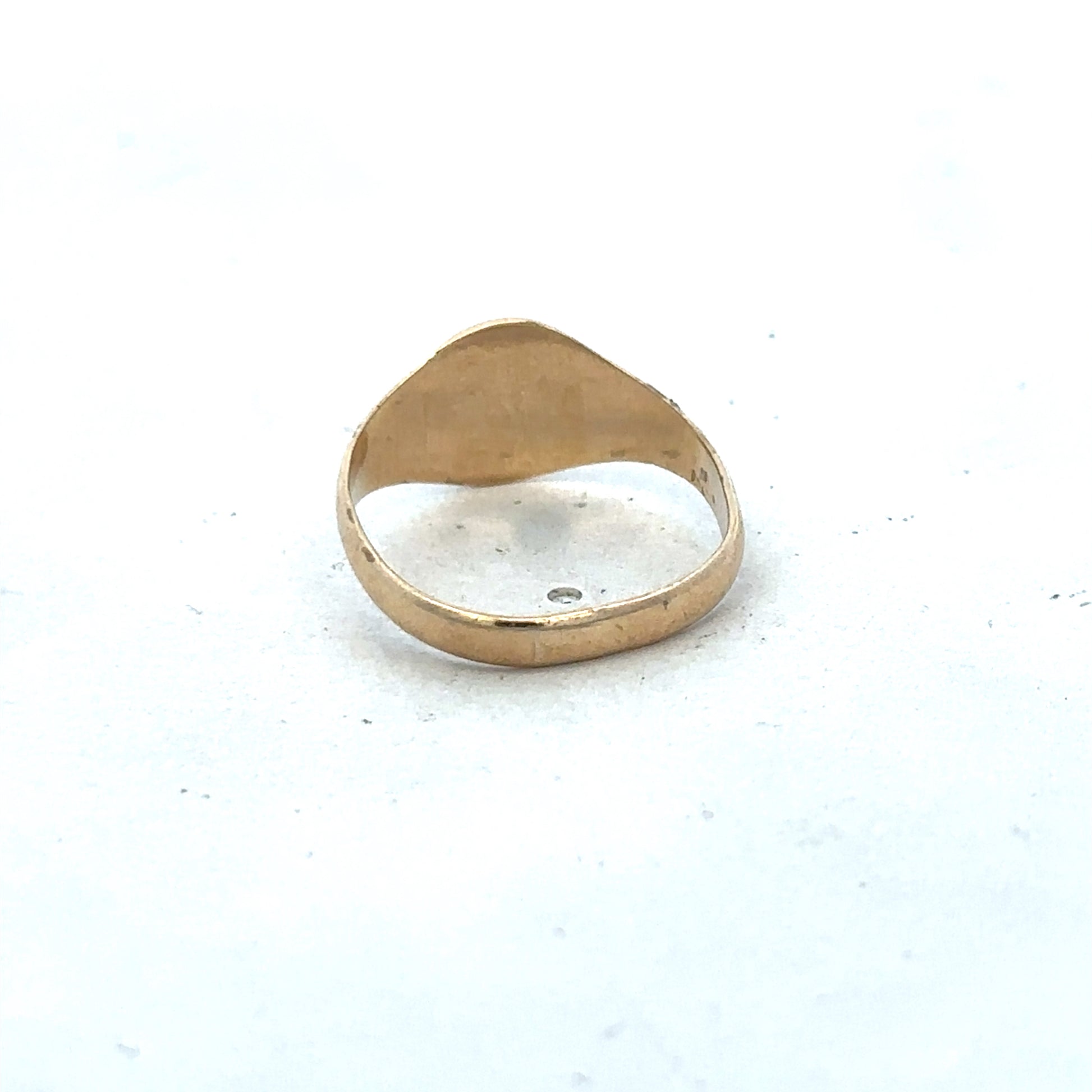 9ct yellow gold signet ring in size M by Reeves and Sons, showing the polished gold surface and classic design.
