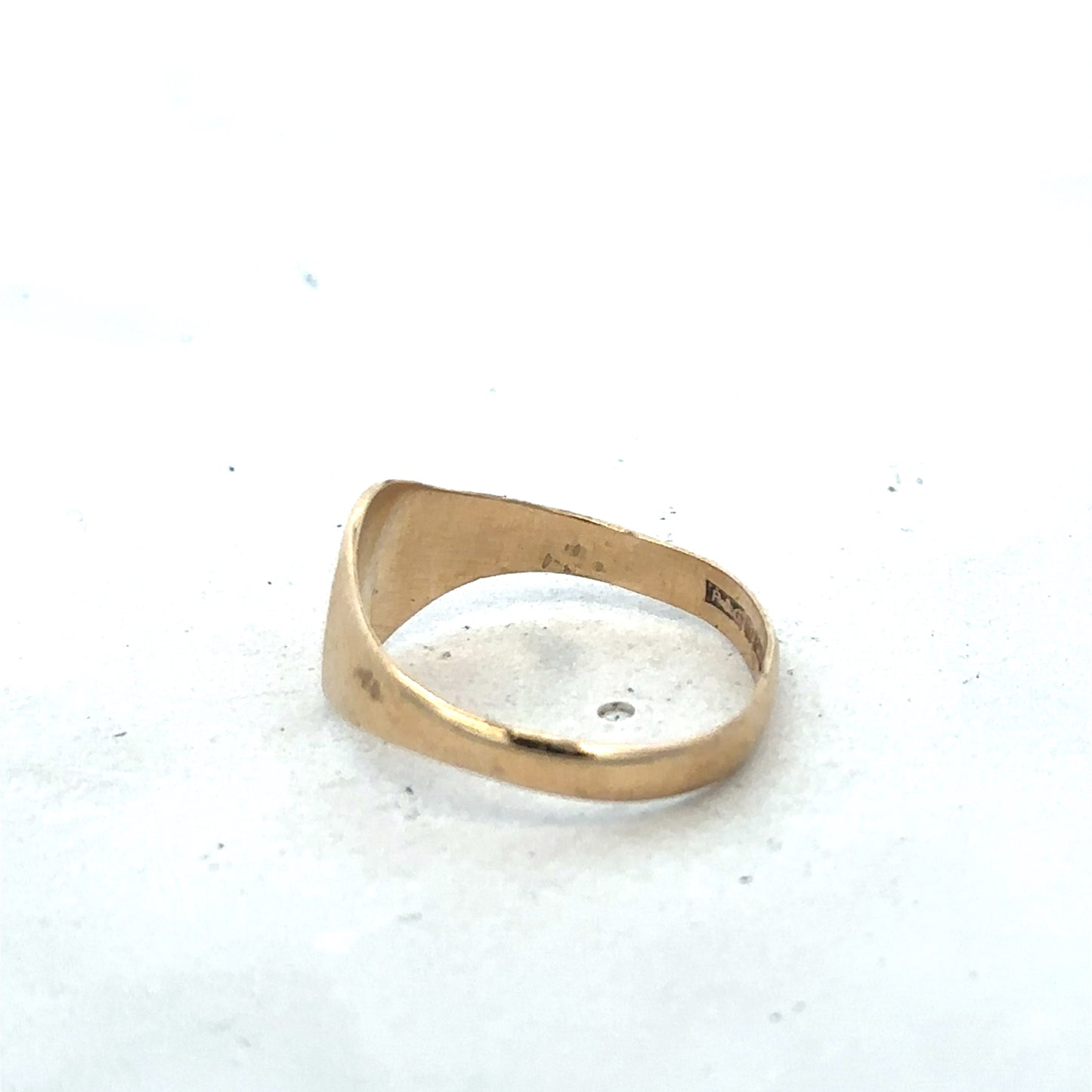 9ct yellow gold signet ring in size M by Reeves and Sons, featuring a polished smooth surface and classic design.