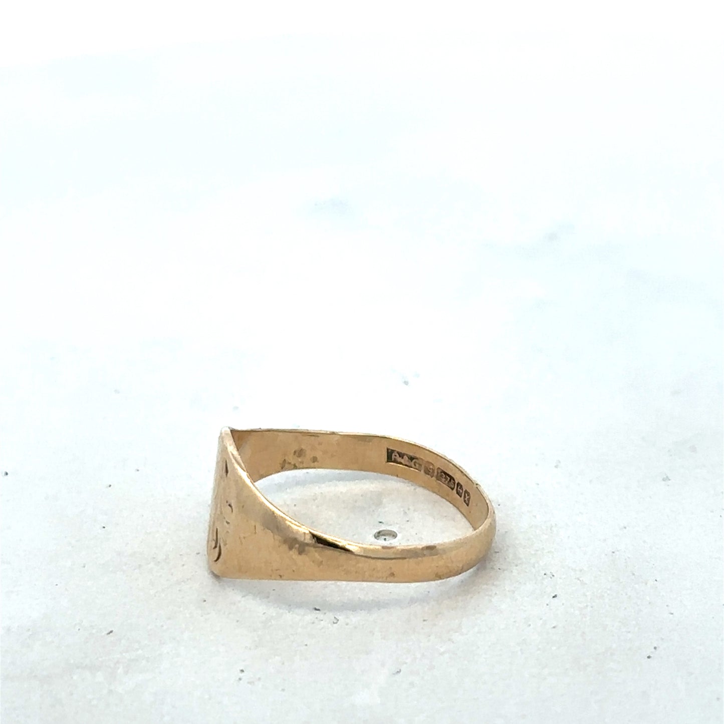 9ct yellow gold signet ring in size M with Reeves and Sons branding, featuring a smooth polished surface and classic design