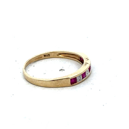 9ct yellow gold ruby and diamond ring in size K1/2, featuring a central ruby and diamond accents by Reeves and Sons.